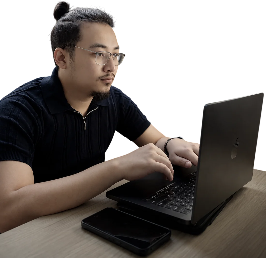 Nikesh Shakya working on a MacBook